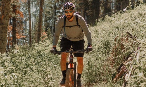 man riding a bike on a trail in the woods
